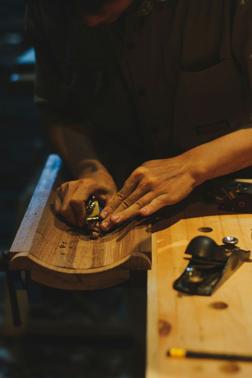 Un rabot à main sur une pièce de bois, à l’établi
